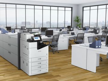 White office desk with printer, potted plants, frame, laptop, and supplies.
