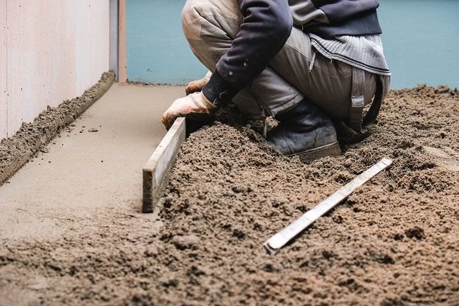 worker scraping the cement