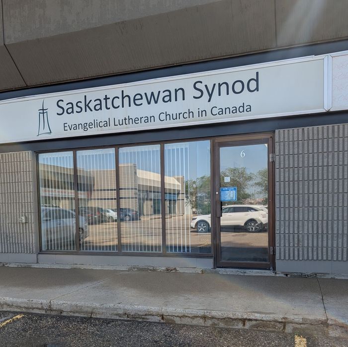 Saskatchewan Synod sign above a storefront entrance with glass doors and windows