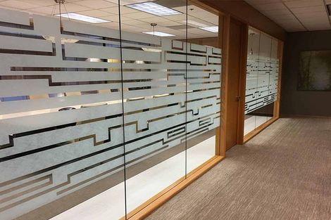 A hallway with a maze design on the glass walls.
