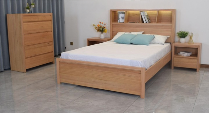 Bedroom furniture set: wooden bed, dresser, and nightstands; soft lighting.