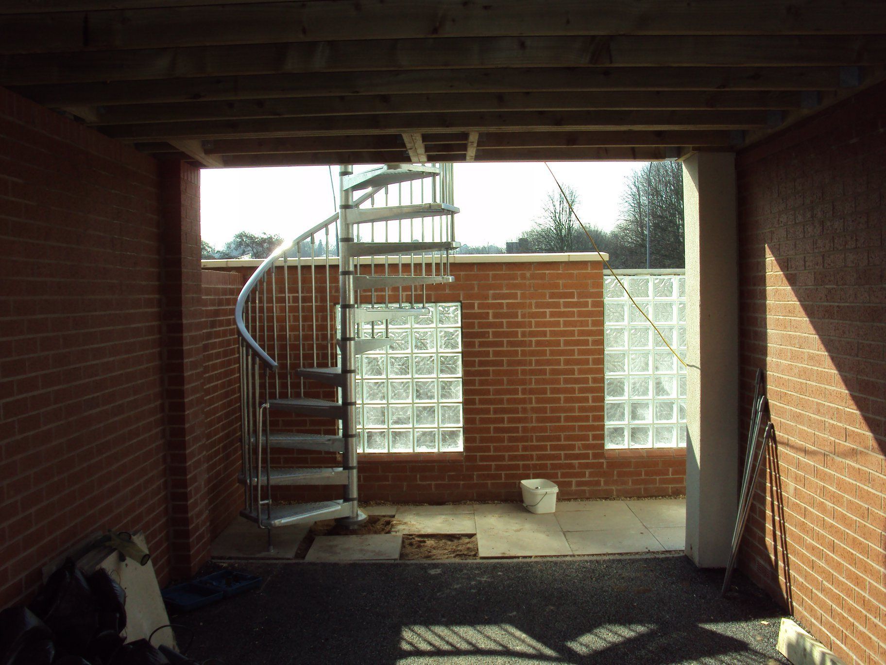 Fire escape with protective wall and glass blocks built in