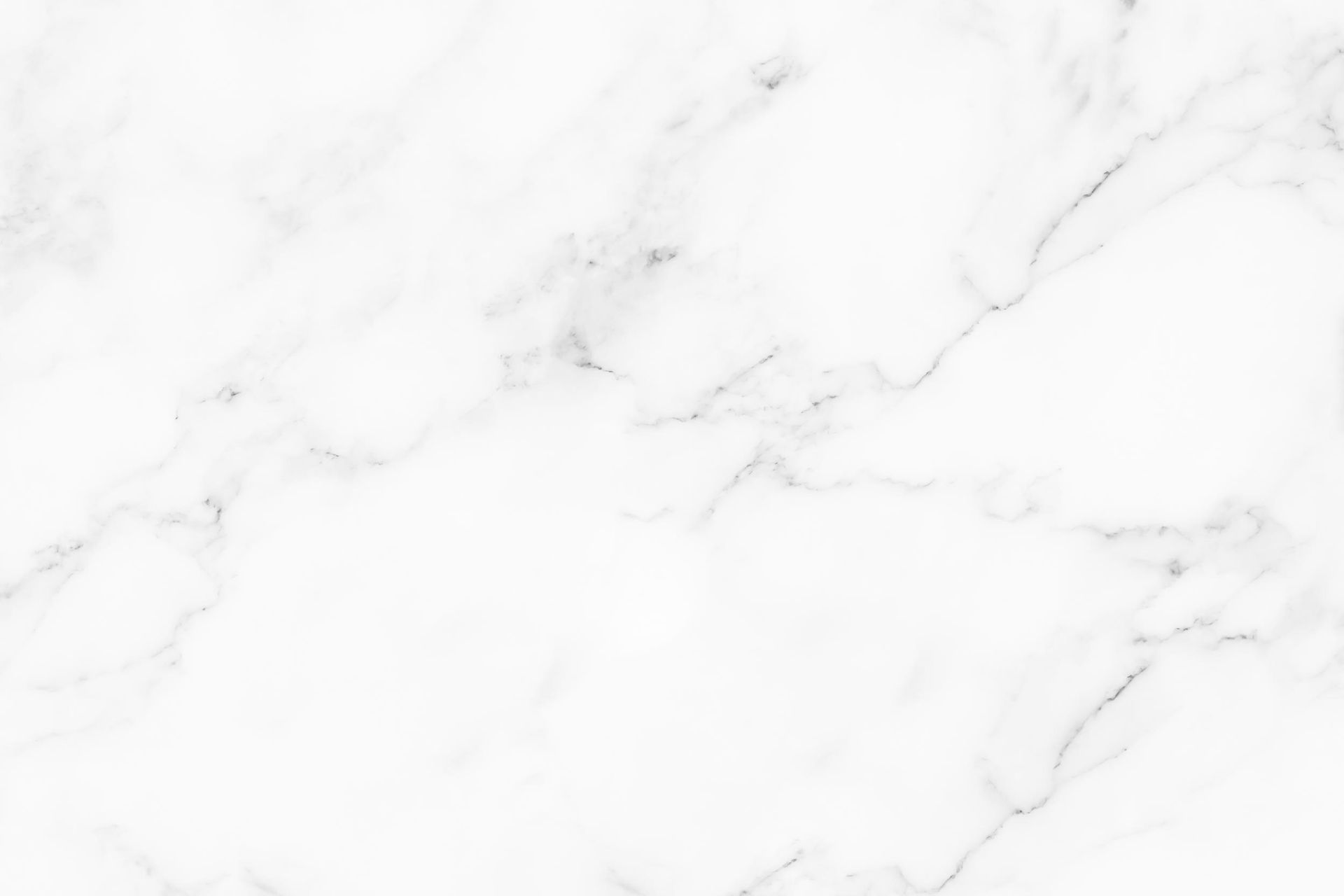 White marble surface with subtle gray veining, a clean minimalist background.