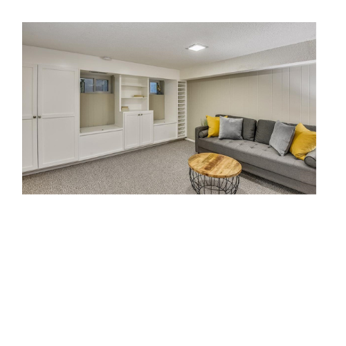 A living room with a couch , table , and shelves.