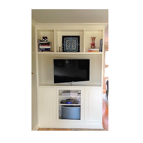 A white entertainment center with a flat screen tv