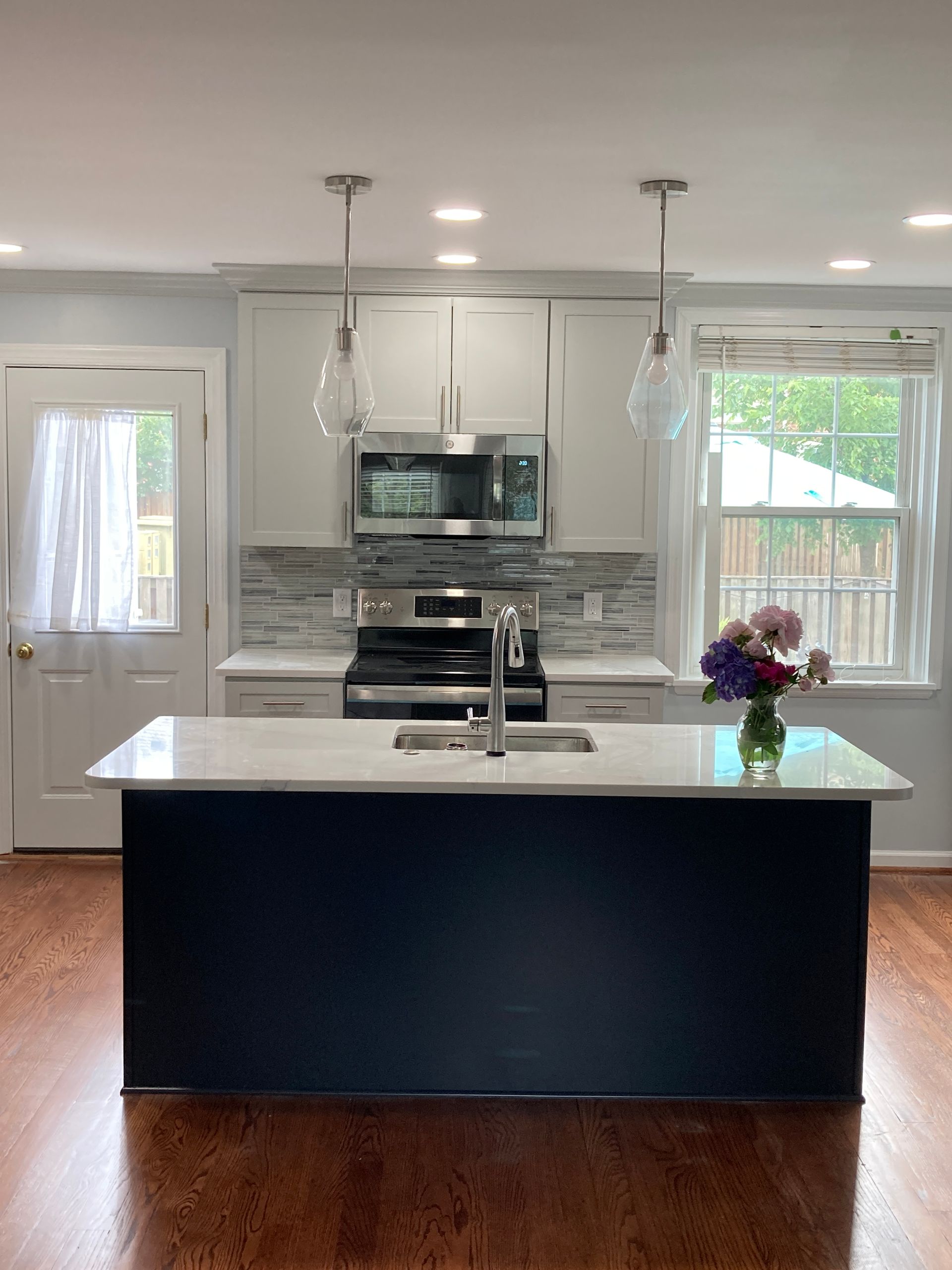A kitchen with a large island and a stove.