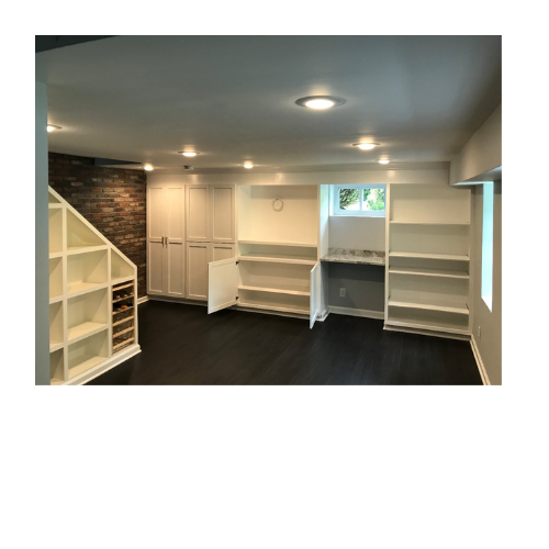 A room with a lot of shelves and cabinets and a brick wall.