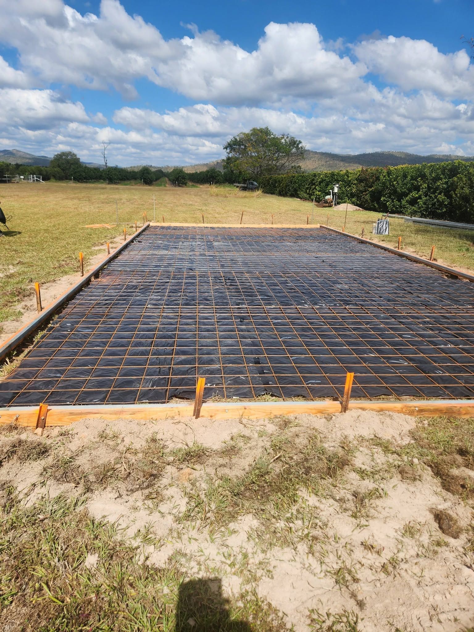 Rebar Foundation Slab Under Construction in A Grassy Field — Sun Co Concrete And Construction in Atherton, QLD