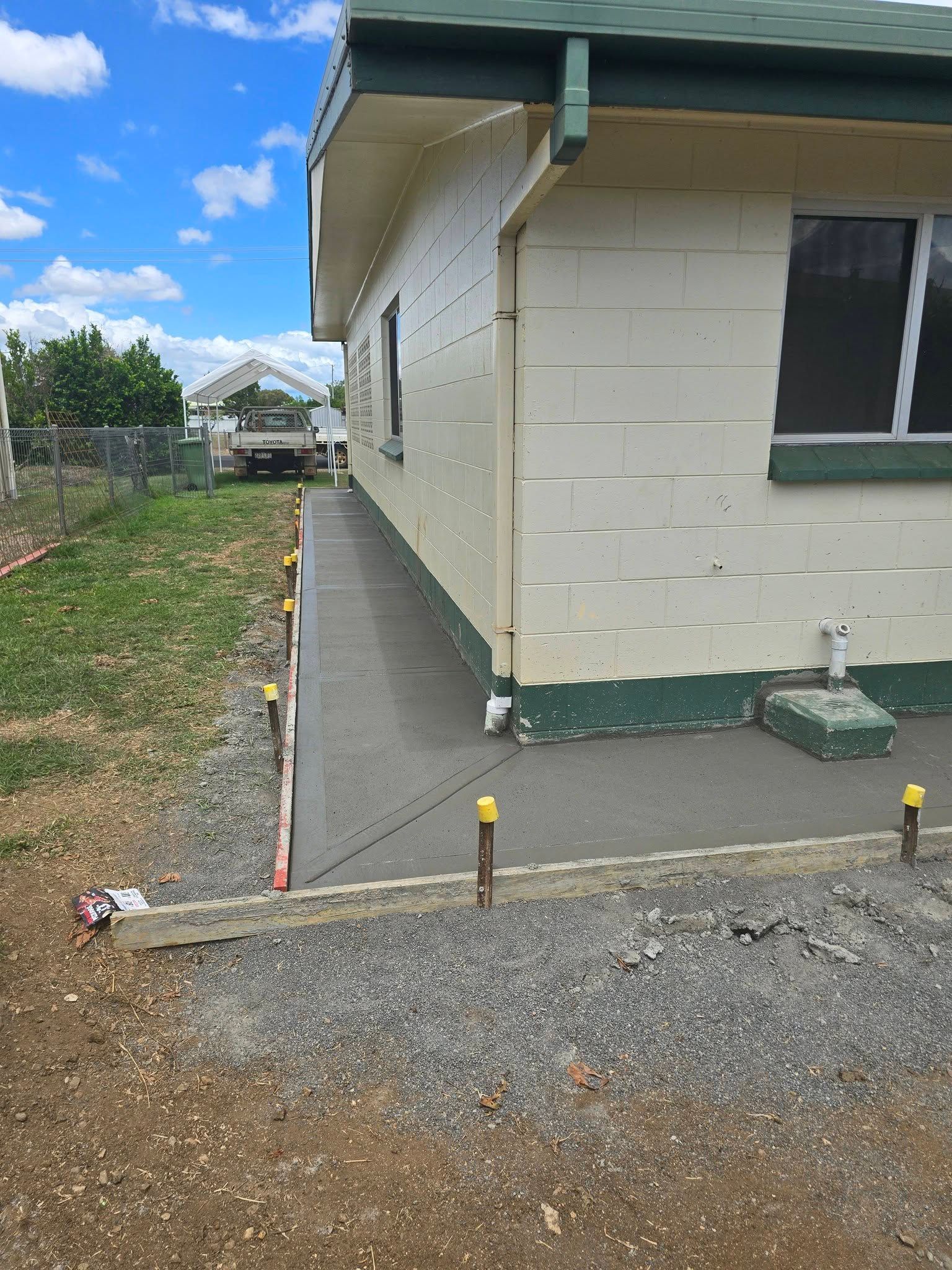 Side of A White House with A Concrete Path, Gravel Driveway — Sun Co Concrete And Construction in Dimbulah, QLD