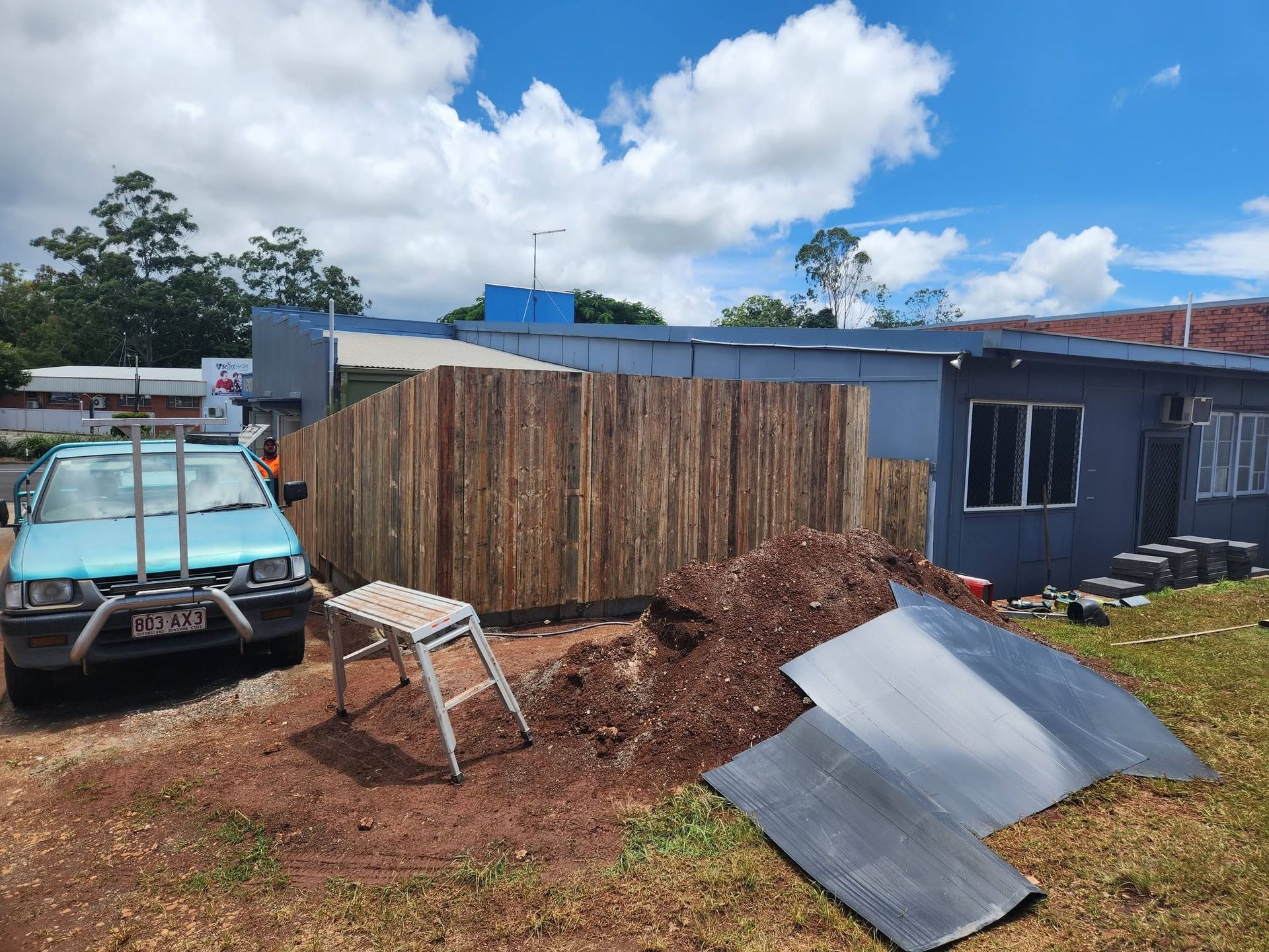 Building Site in A Yard with A Pile of Soil and Metal Sheeting — Sun Co Concrete And Construction in Cairns, QLD