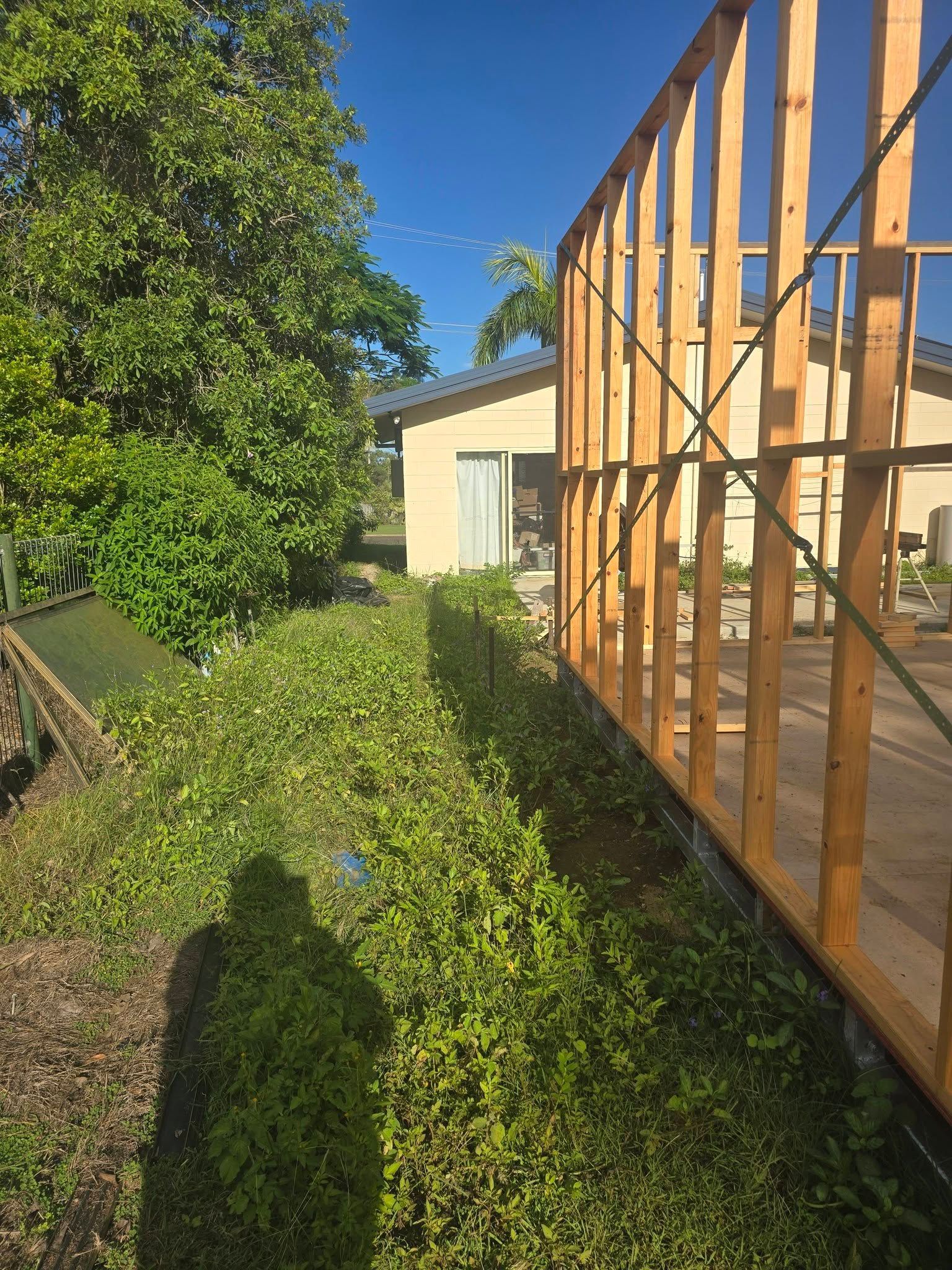 Backyard Garden Beside a Wooden Framed Structure in Bright Sunlight — Sun Co Concrete And Construction in Dimbulah, QLD