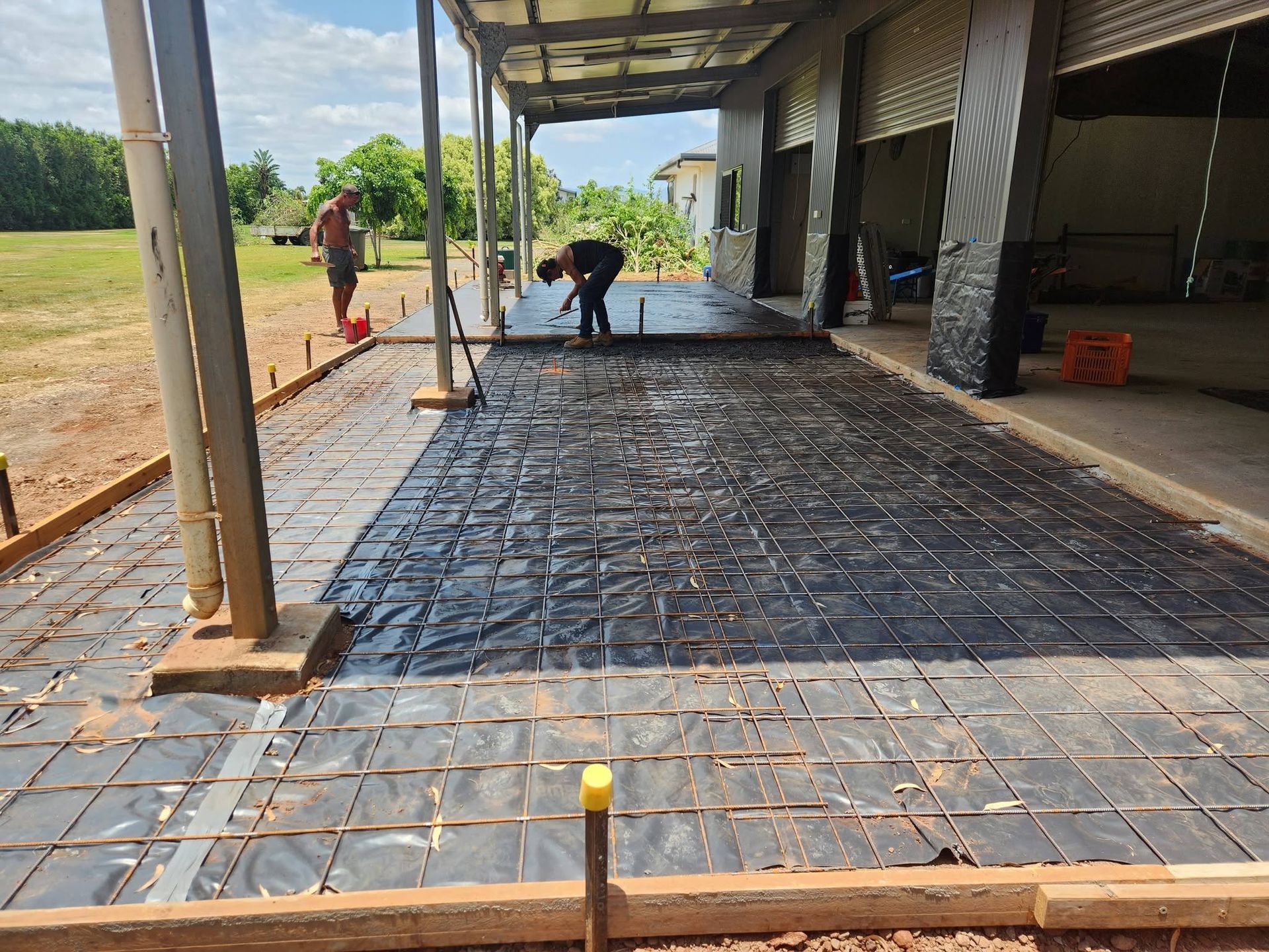 Workers Smoothing Concrete on A Construction Site — Sun Co Concrete And Construction in Dimbulah, QLD