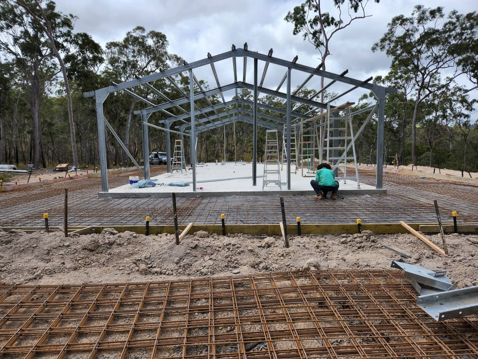 Steel Building Frame Under Construction in A Wooded Area — Sun Co Concrete And Construction in Dimbulah, QLD