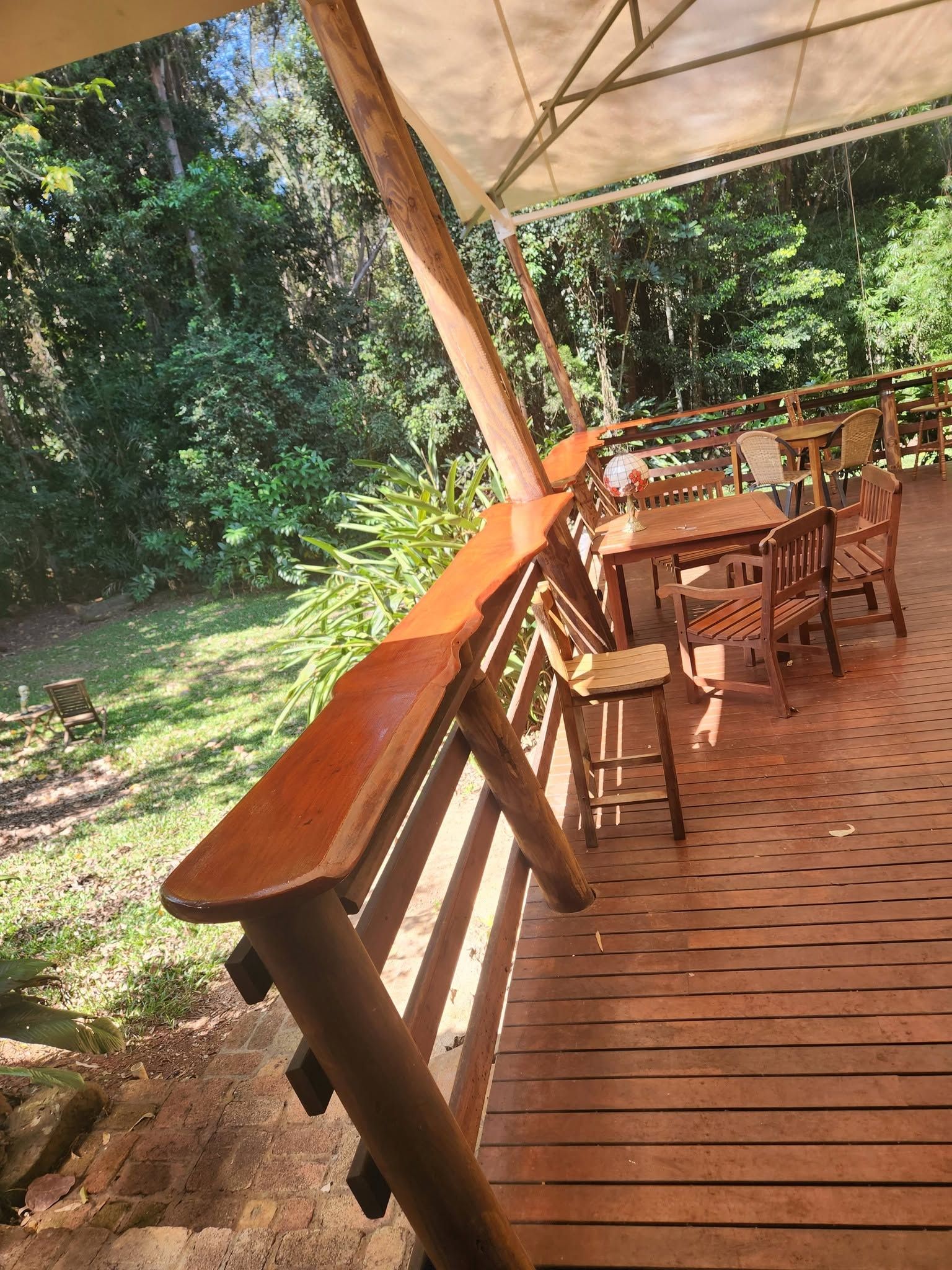 Wooden Deck Patio with Tables and Chairs Under a Canopy — Sun Co Concrete And Construction in Mareeba, QLD