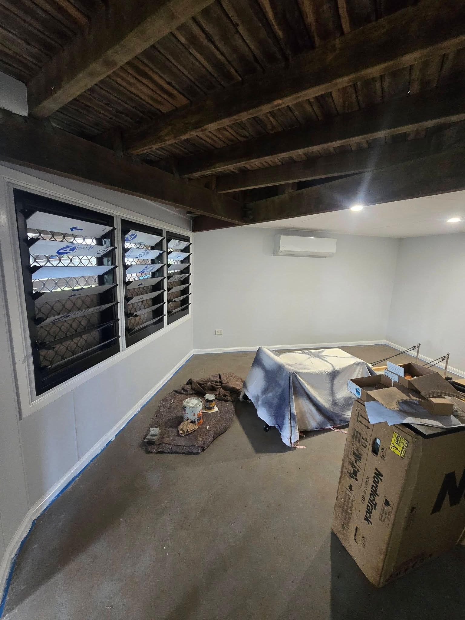 Partially Renovated Room with Exposed Wood Ceiling, Window Shutters — Sun Co Concrete And Construction in Cairns, QLD