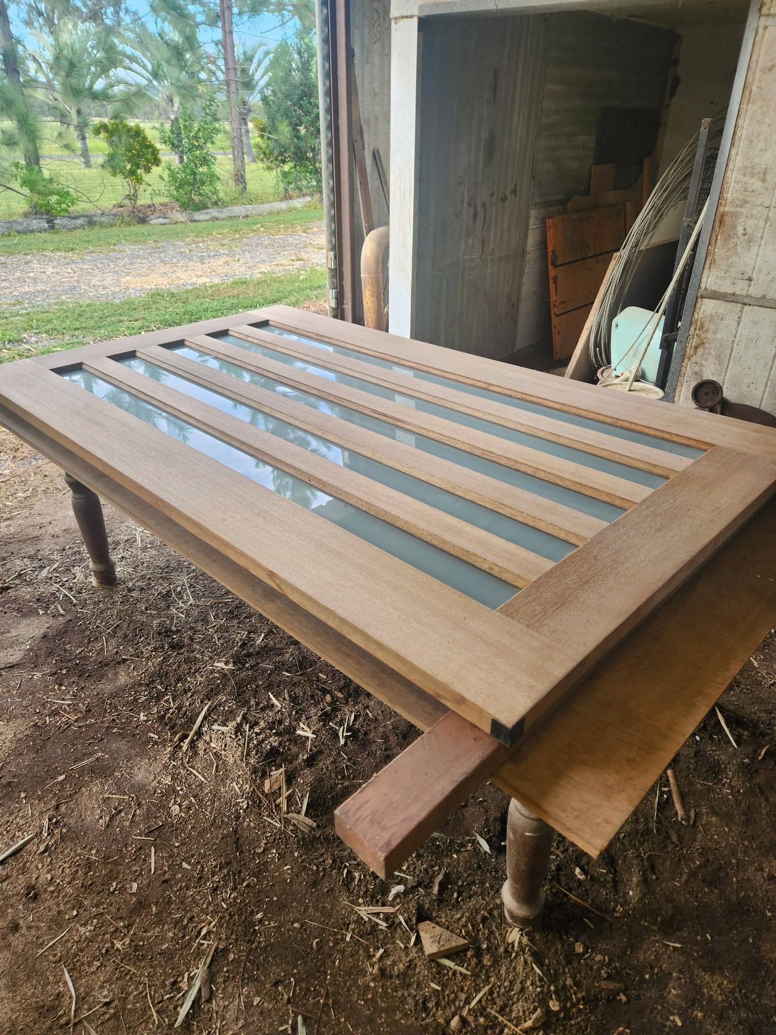 Wooden Slatted Bed Frame on Sawhorses Outside a Shed — Sun Co Concrete And Construction in Dimbulah, QLD