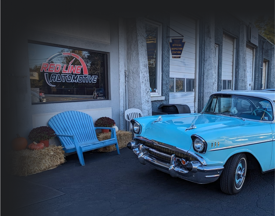 A light blue classic car parked in front of