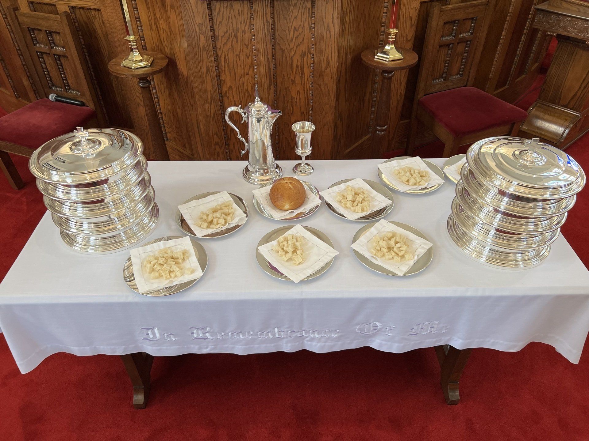 Communion table set with trays, bread, and chalice, in the Sanctuary of First Presbyterian  Church Rock Hill.
