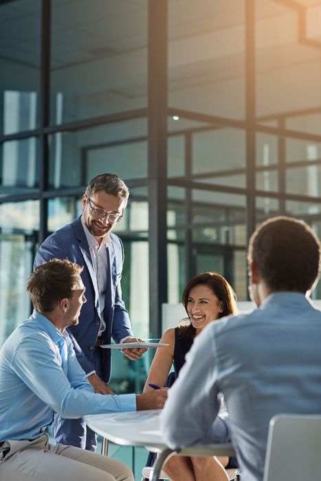 A group of business people are having a meeting in an office.