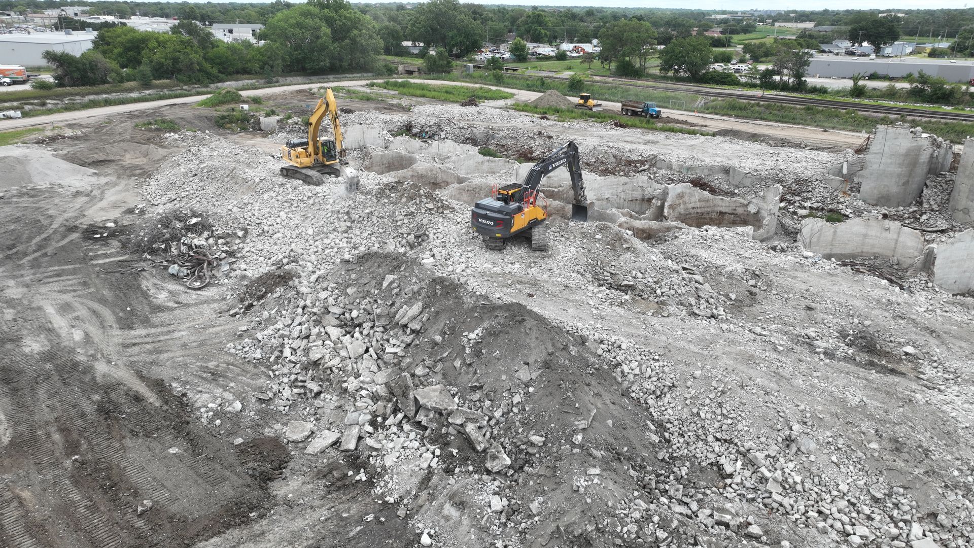View of the former Hansen-Mueller grain elevator complex at 3001 Cornhusker Highway during CL Construction's demolition project in Lincoln, Nebraska, featuring tall concrete silos being dismantled.
