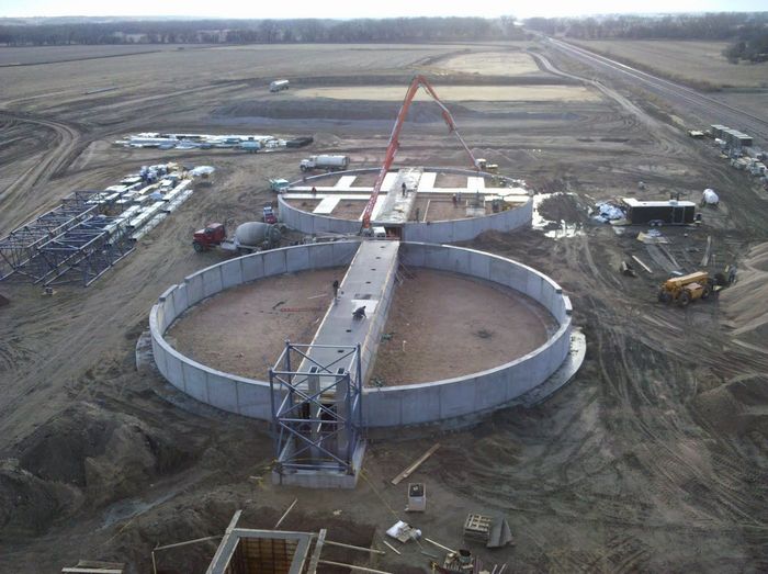 An aerial view of a construction site with a large circular structure in the middle