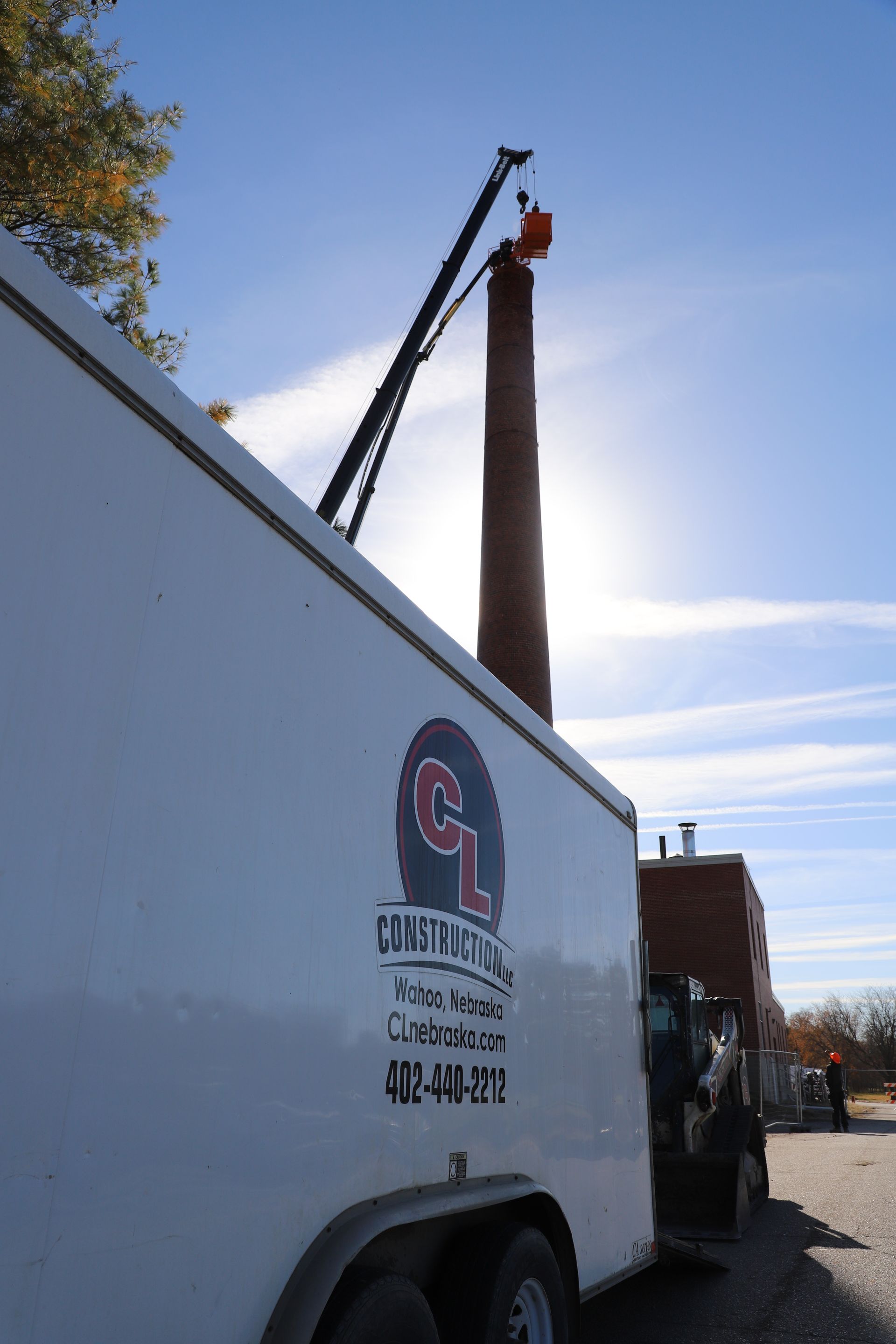 CL Demolition team executing controlled hand demolition of a 143-foot smokestack at the former Lincoln Regional Center facility in Lincoln, Nebraska