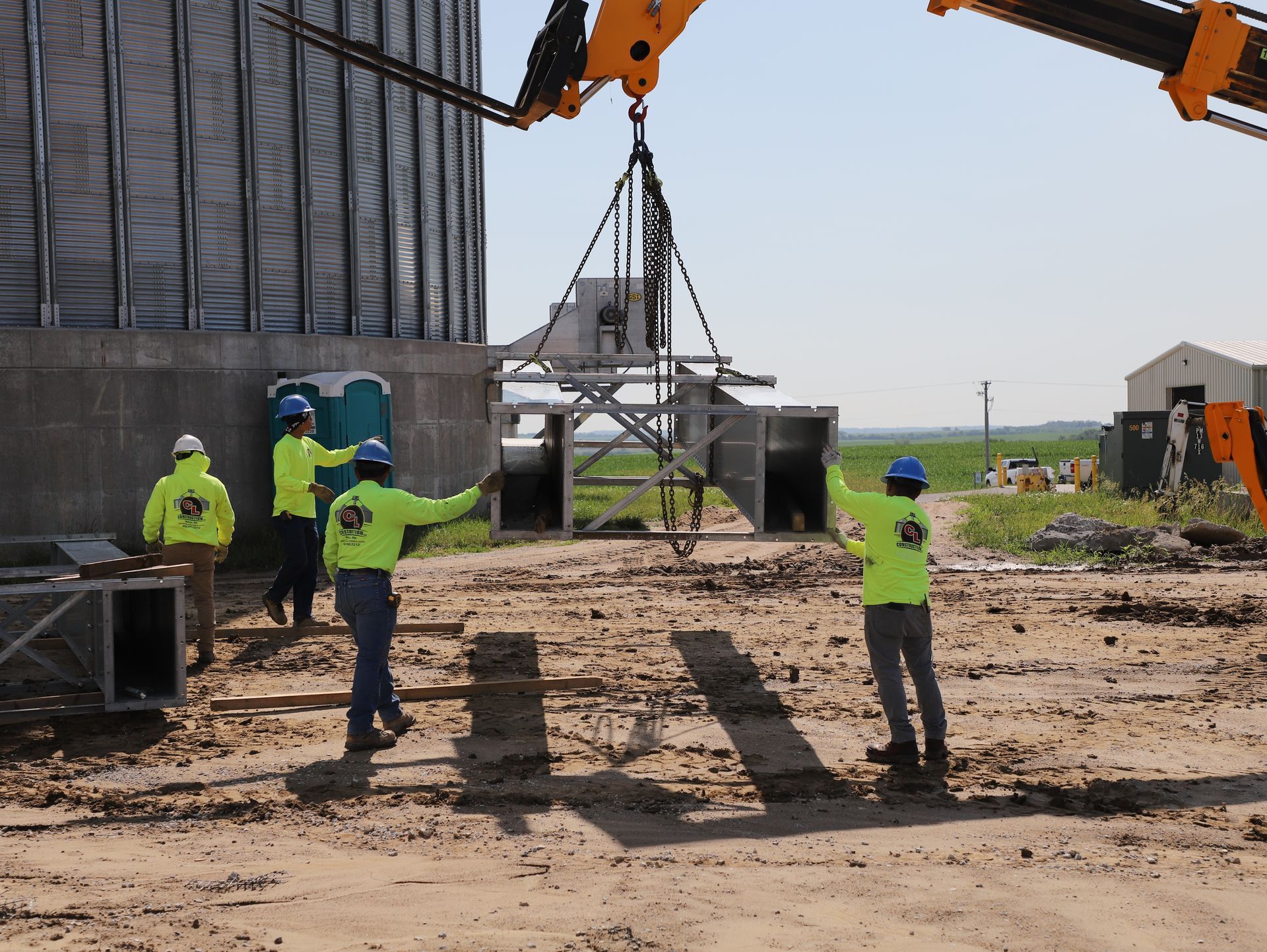 A group of construction workers standing in front of a crane