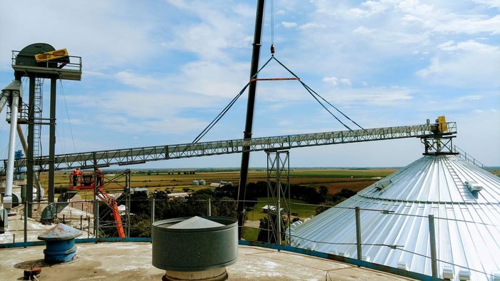 A large metal structure with a conveyor belt going through it