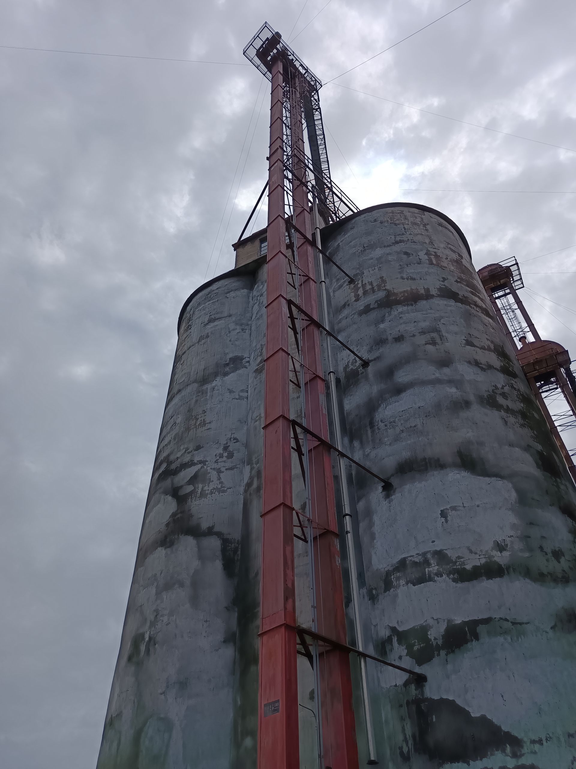 A very tall building with a crane on top of it.