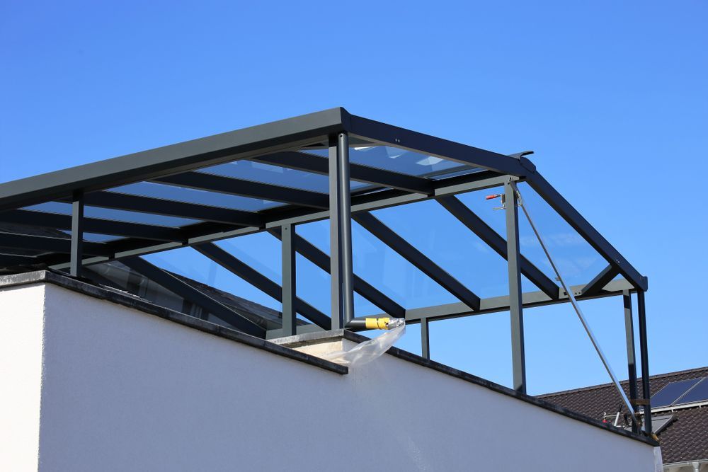 A Glass Canopy on the Roof of a Building With a Blue Sky in the Background — Sun City Sheetmetal In Mt Isa, QLD