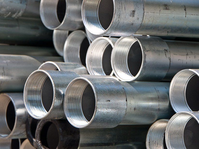 A Bunch of Metal Pipes Stacked on Top of Each Other — Sun City Sheetmetal In Garbutt, QLD