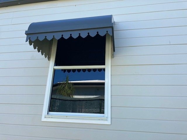 A Glass Canopy on the Roof of a Building With a Blue Sky in the Background — Sun City Sheetmetal In Garbutt, QLD