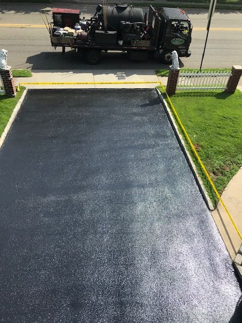 A truck is parked in the driveway of a house.