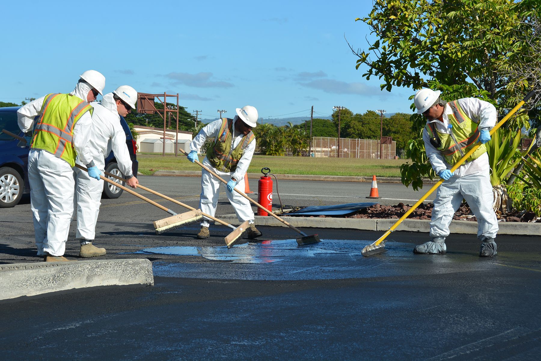 A group of construction workers are working on a parking lot A group of construction workers are working on a parking lot