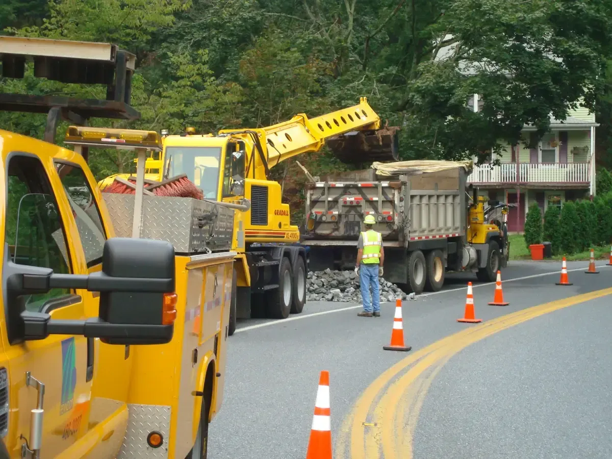 A yellow truck is parked on the side of the road