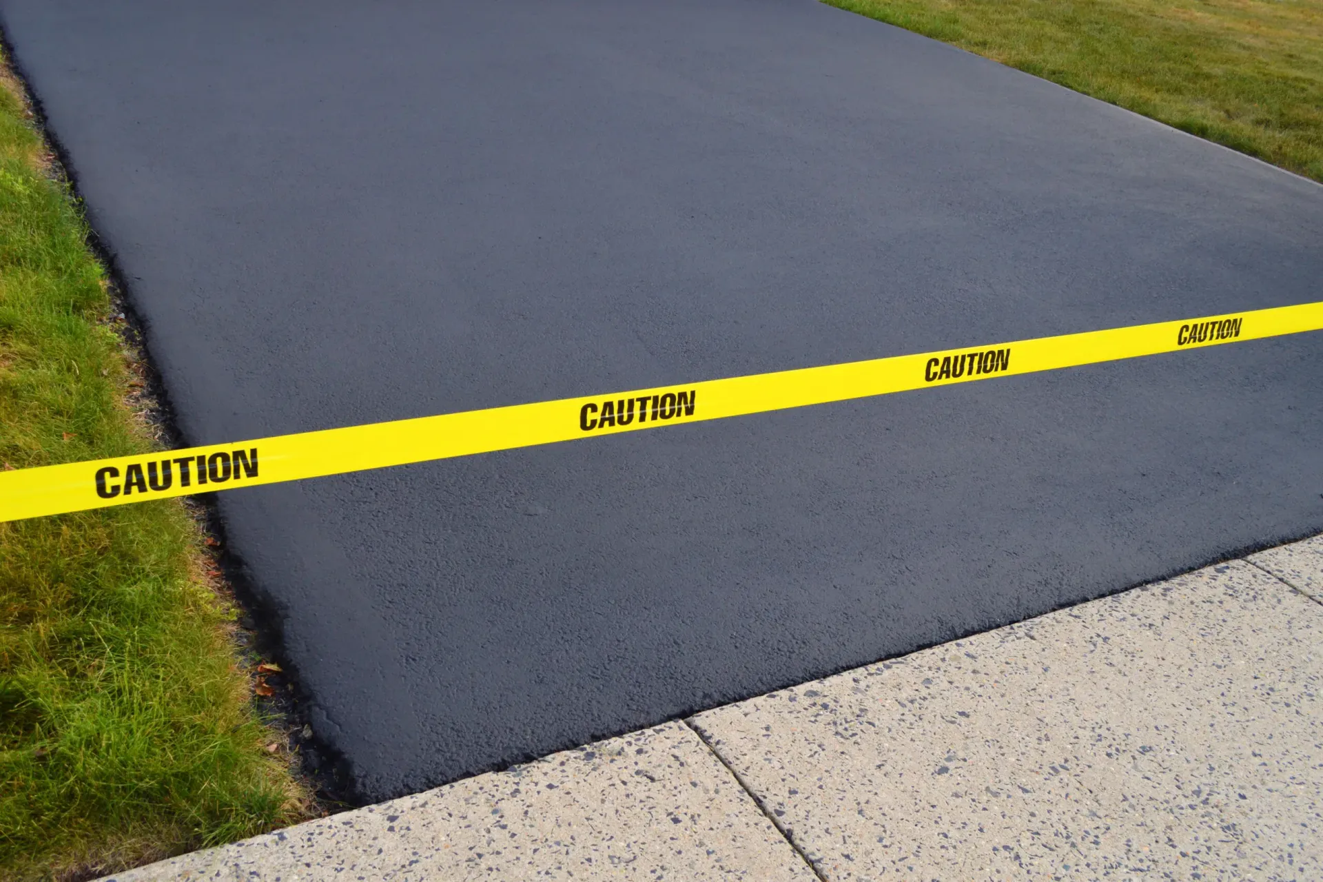 A caution tape is on the side of a road A caution tape is on the side of a road
