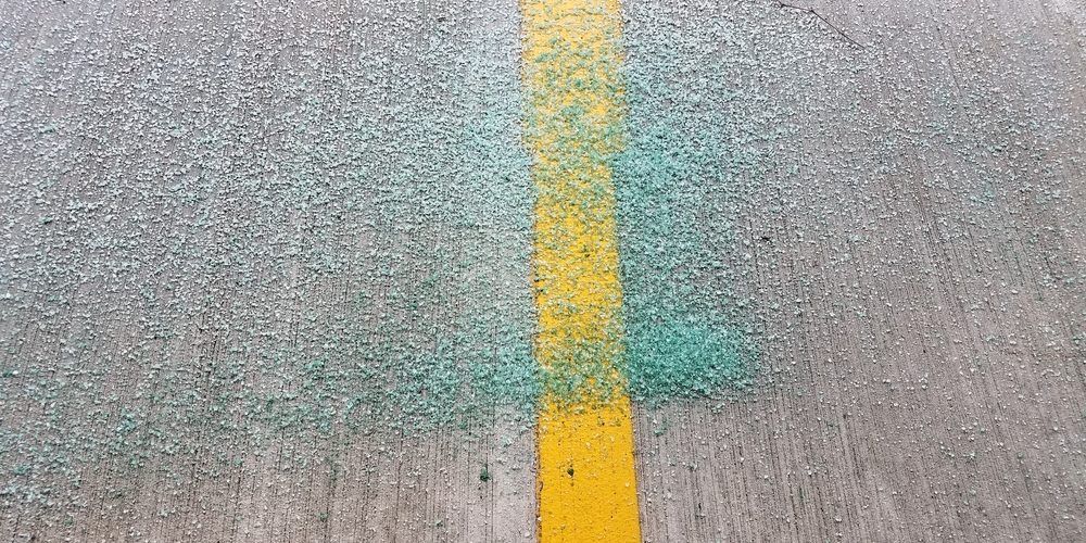 A yellow line is painted on the side of a road.