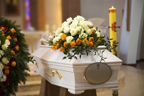 funeral parlour with coffin and floral arrangement