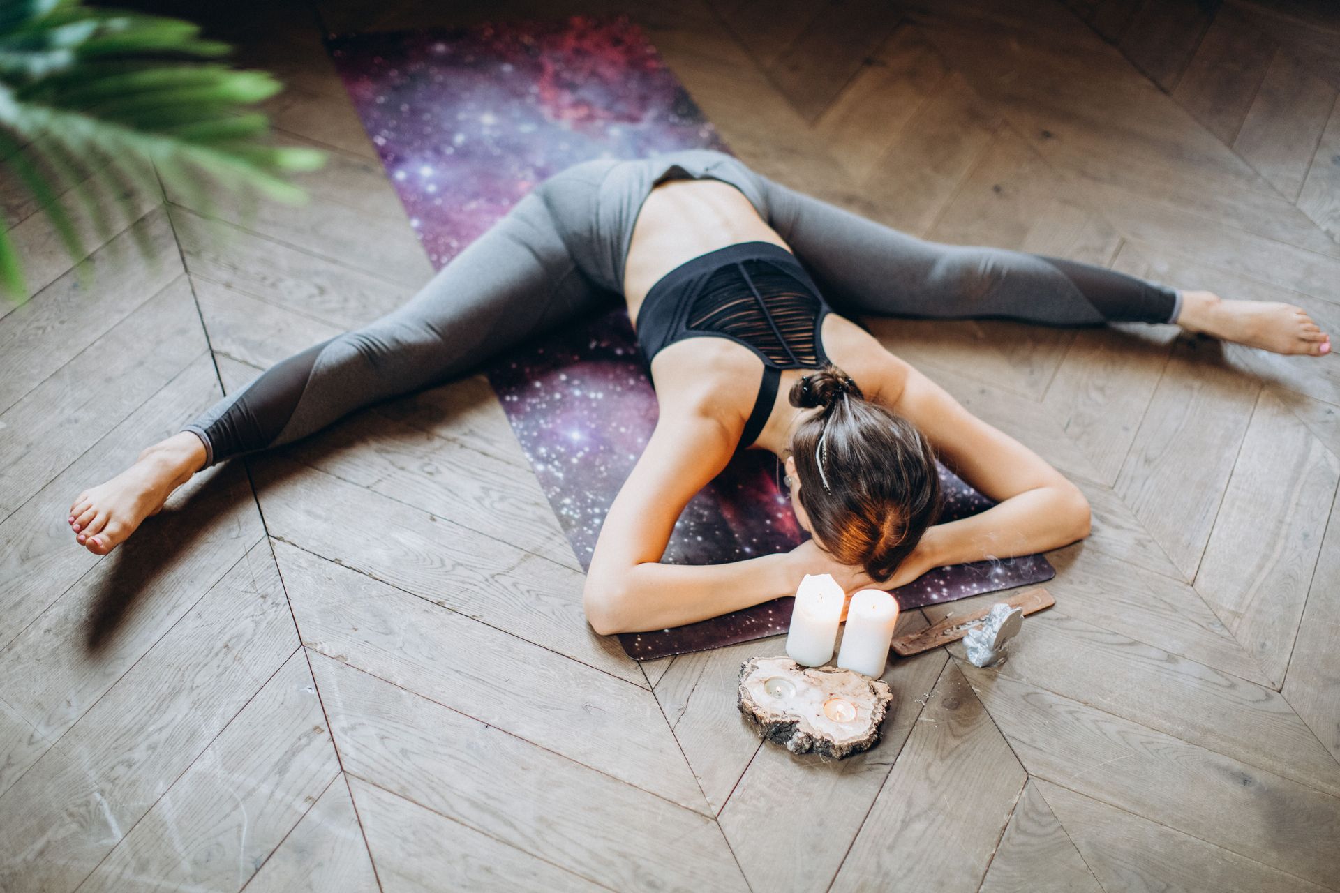 Woman lying face down on a yoga mat in a resting child's pose