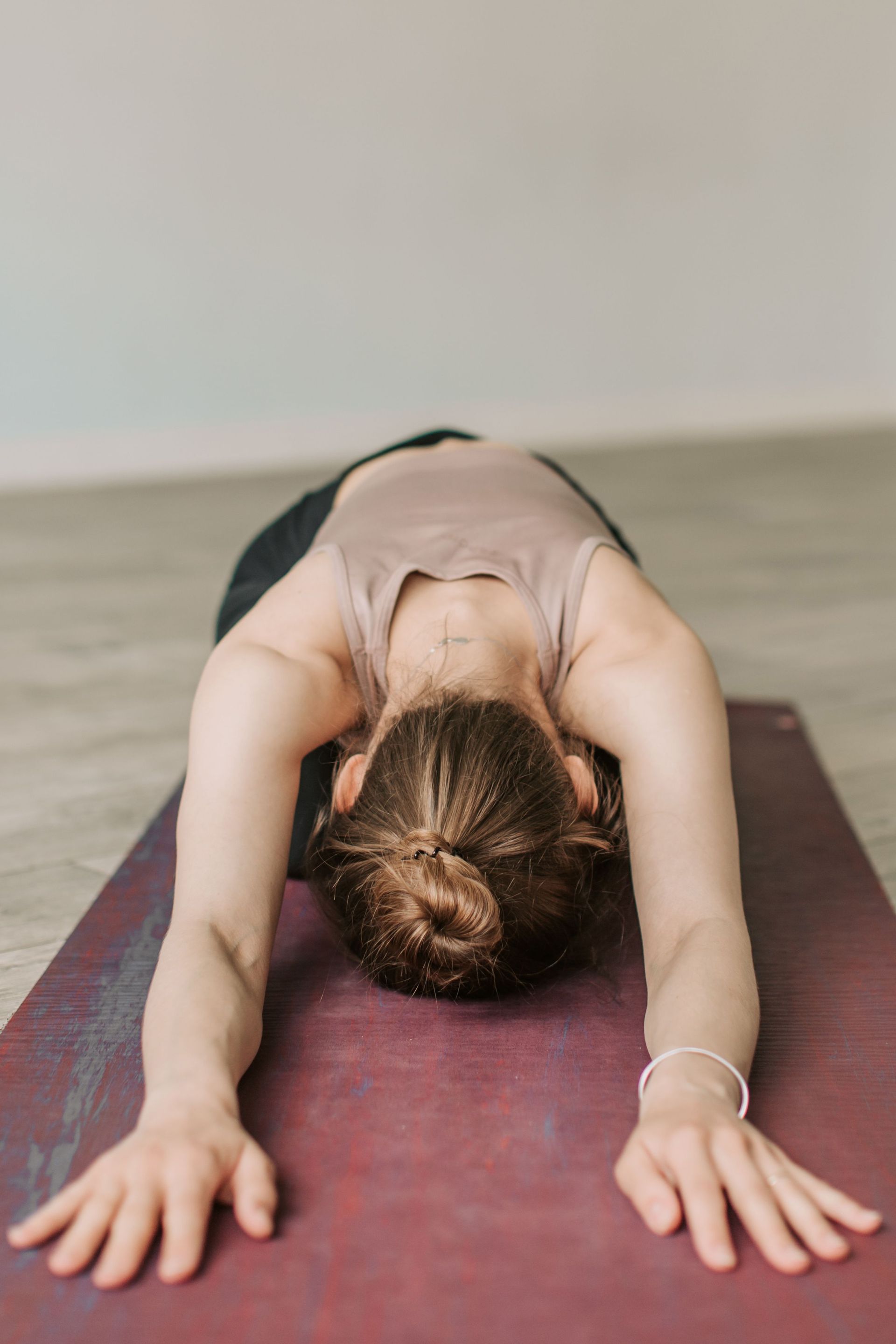 Close-up of a woman bending forward in a yoga stretch