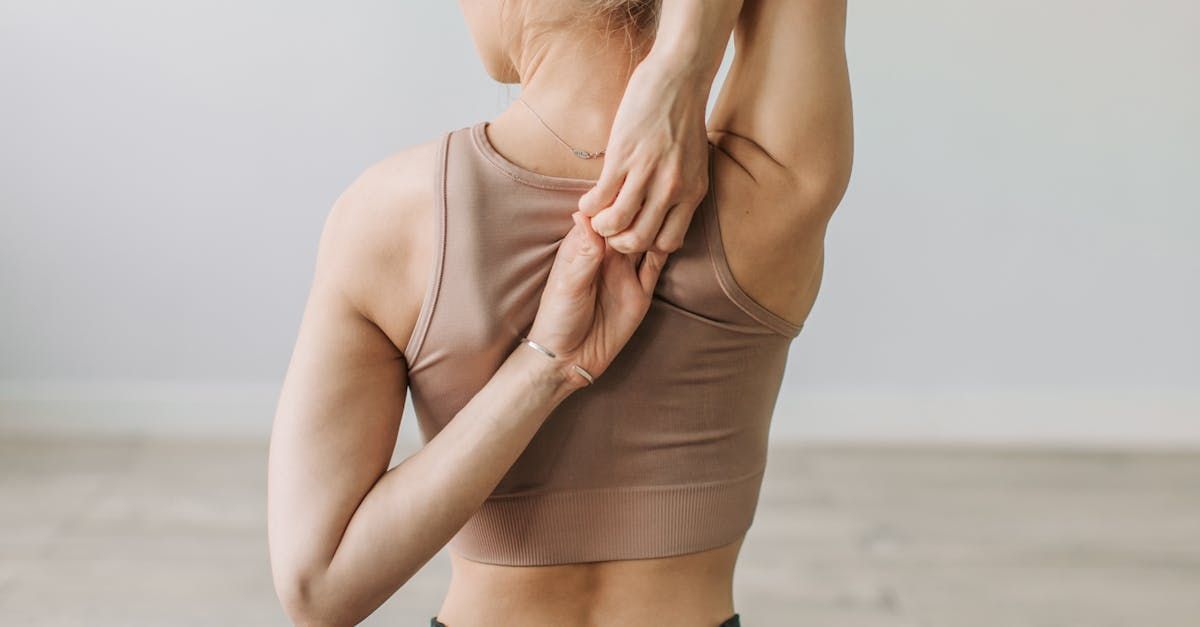 Close-up of a woman stretching her arm behind her back