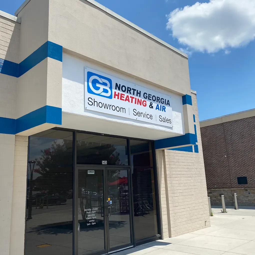 North Georgia Heating & Air's store front featuring a white sign with blue and red text on a tan building.