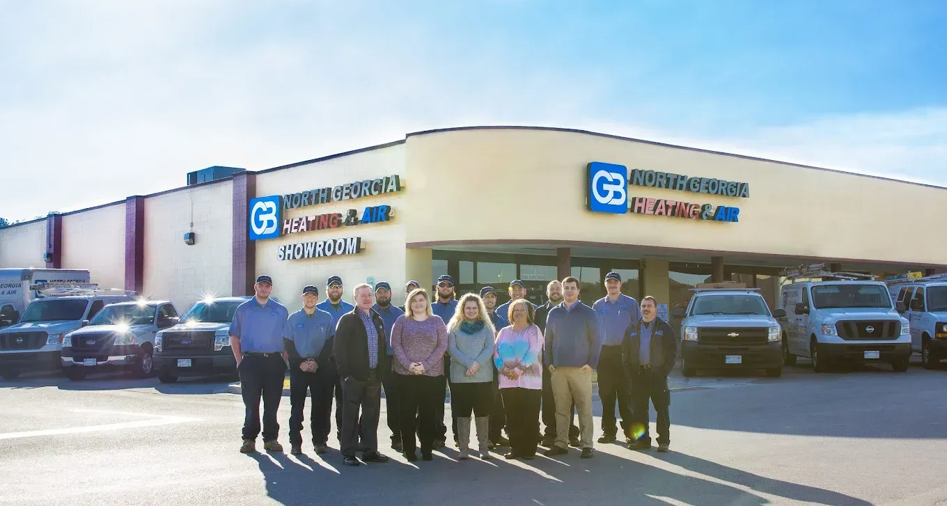 A group of employees standing in front of a commercial building with a 