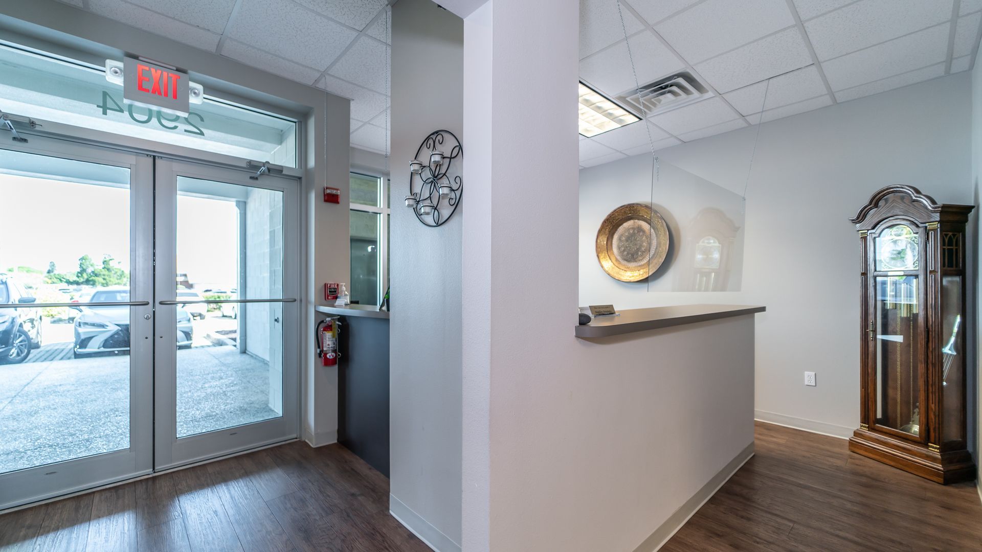 A hallway in a building with a clock on the wall.