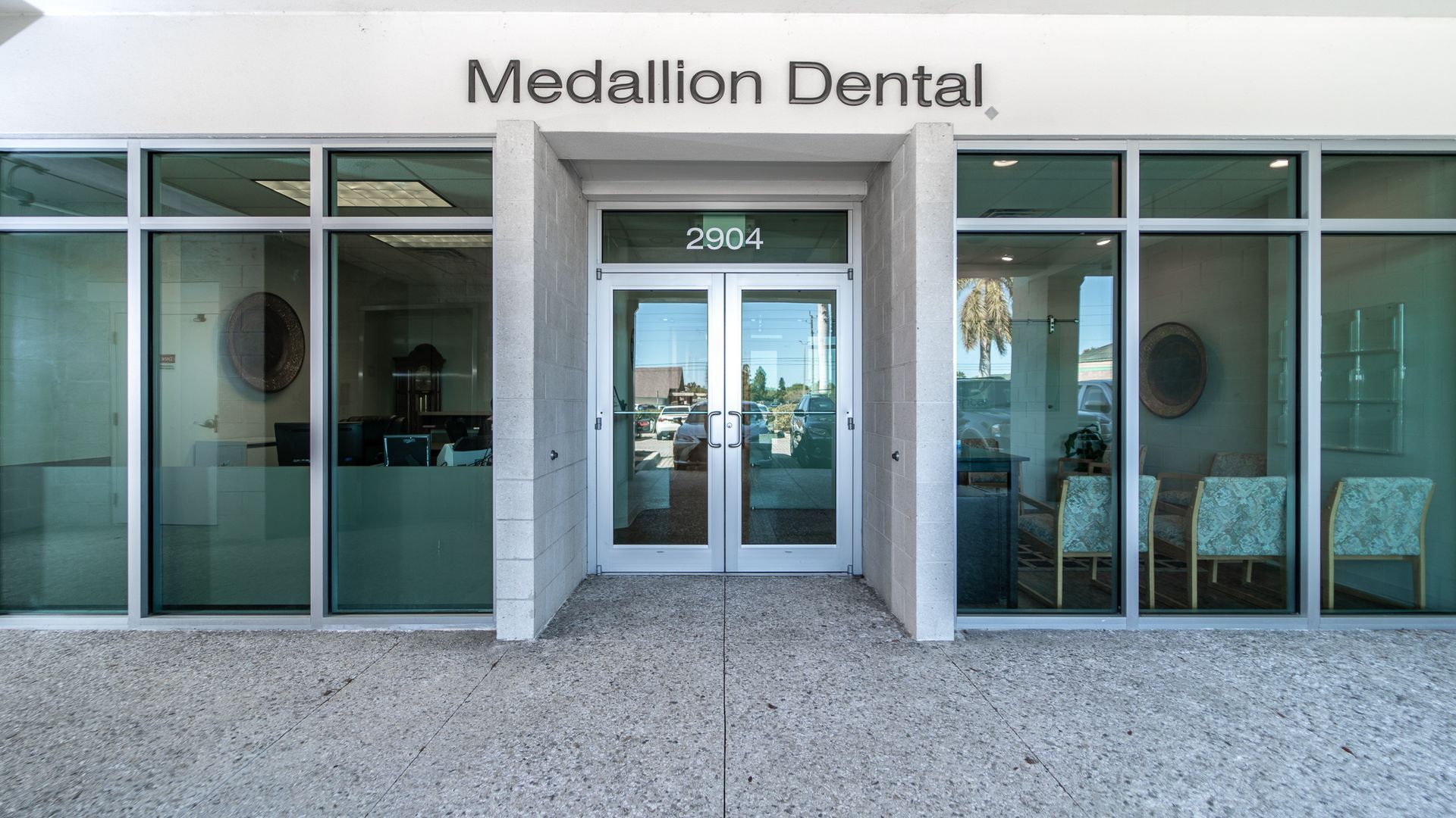 The front of a dental office with a sign that says medallion dental.