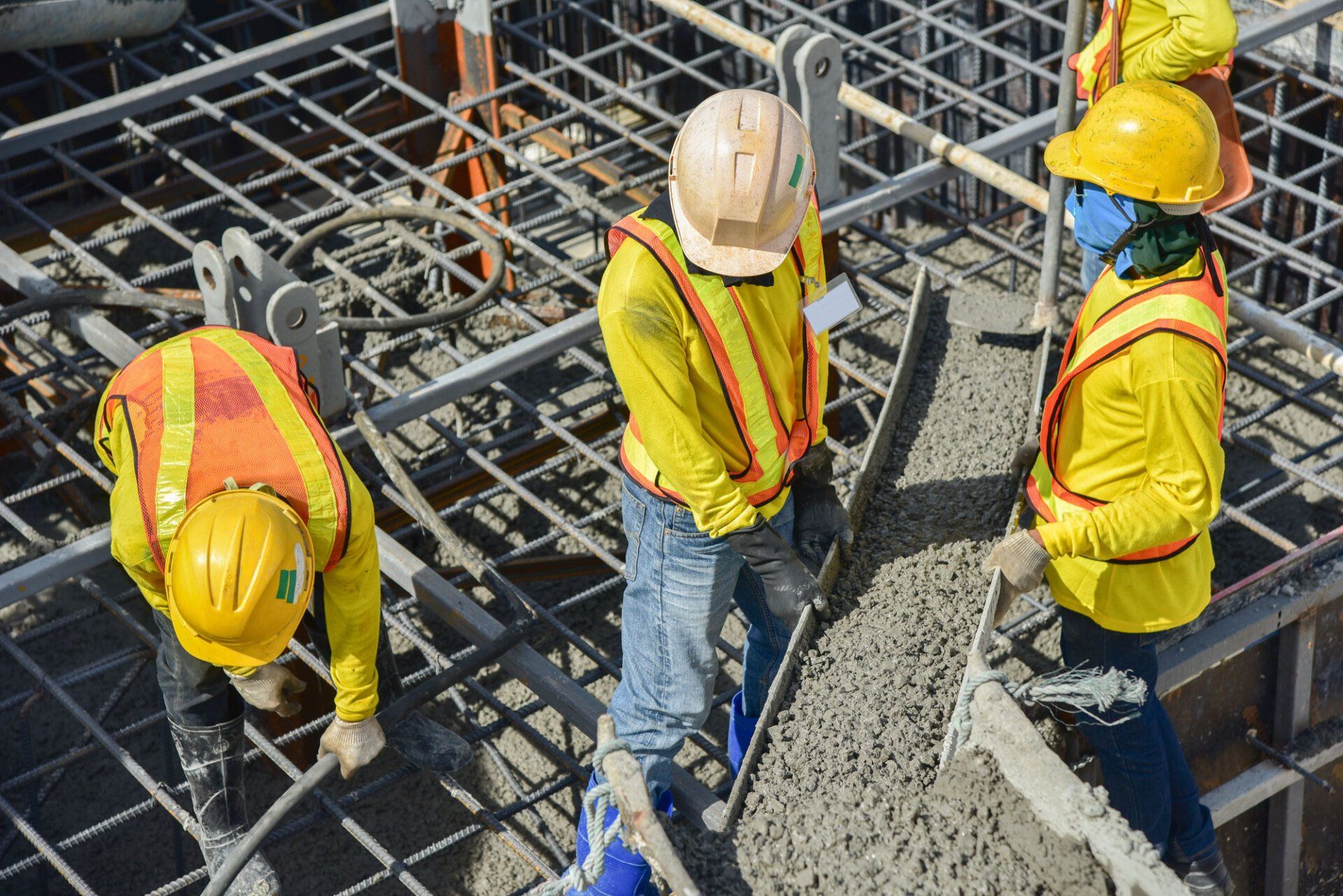 Construction workers pouring Concrete to floors of building in construction site