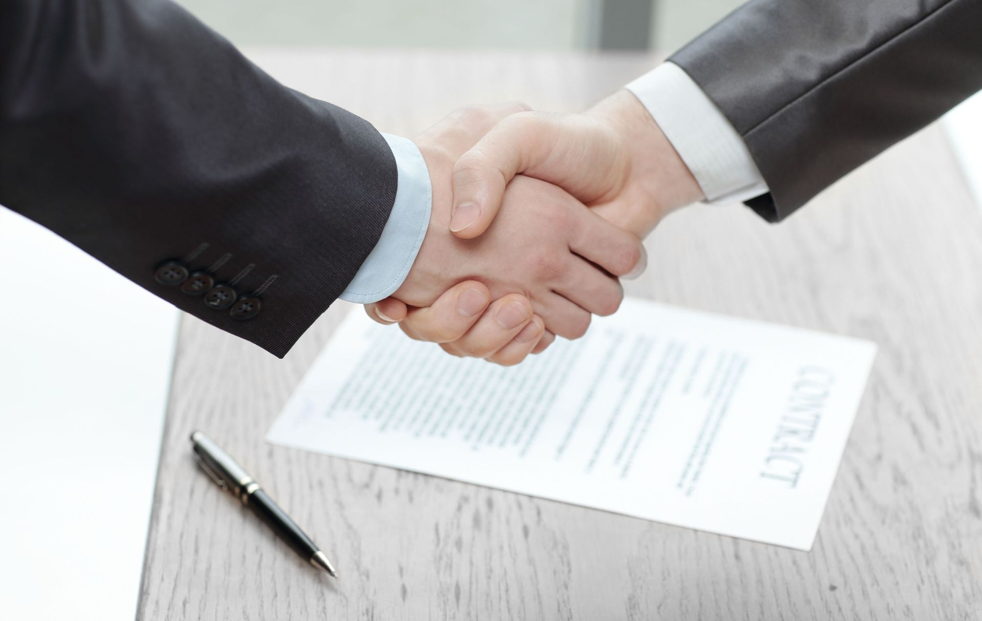 Handshake of business people after the signing of the contract.