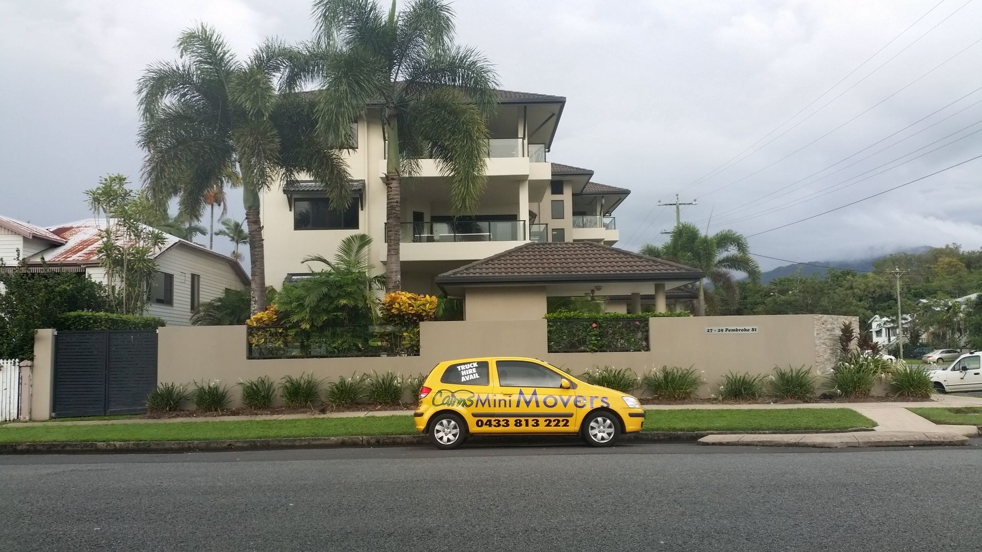 Yellow Car Parked on a Residential Street — Cairns Mini Movers In Mount Sheridan, QLD