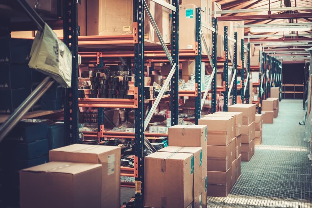 Racks Filled With Stacked Cardboard Boxes — Cairns Mini Movers In Mount Sheridan, QLD