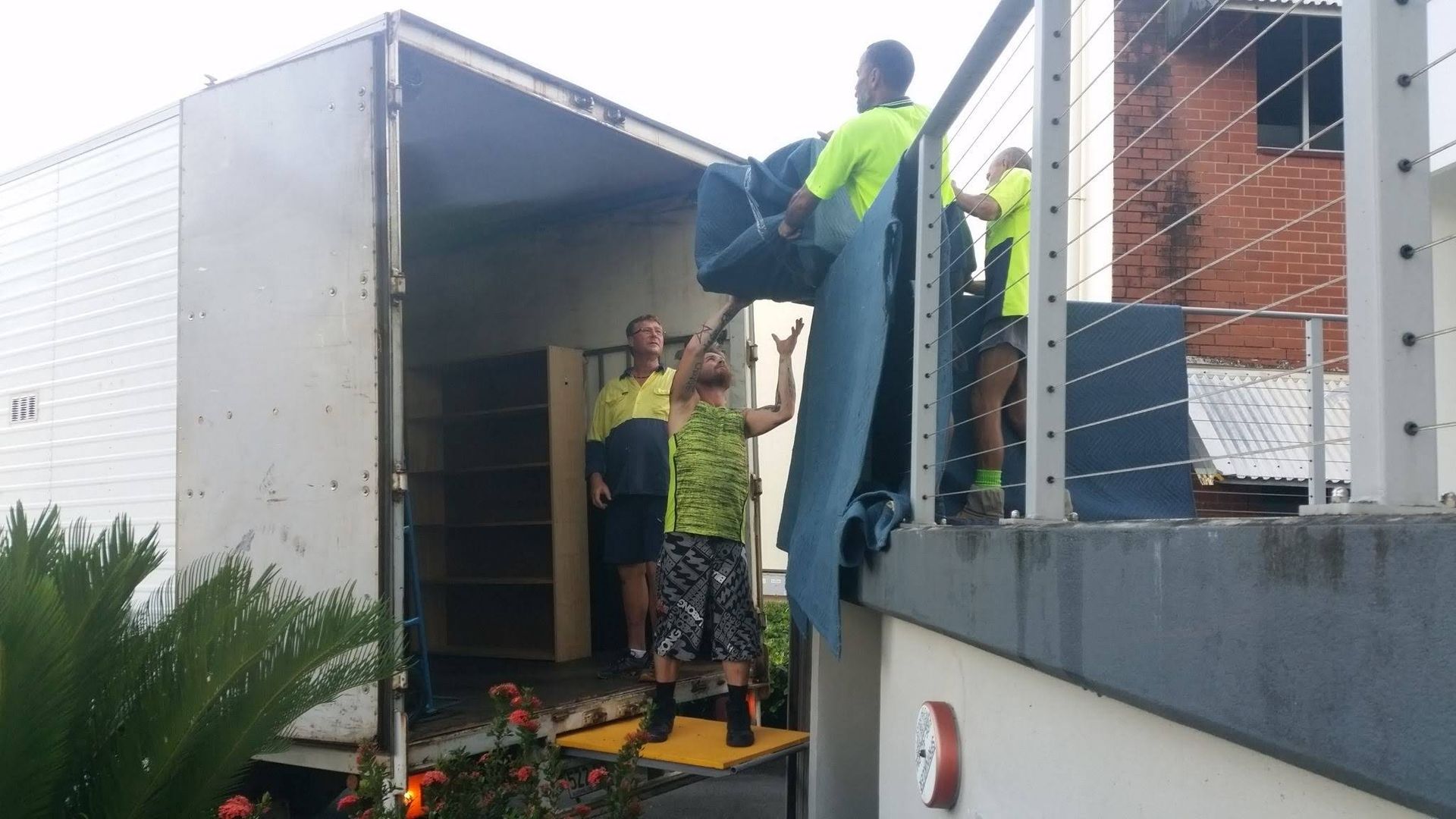 Workers Are Moving Furniture From a Truck — Cairns Mini Movers In Mount Sheridan, QLD